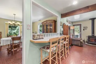Kitchen eat in area with bar and stools.