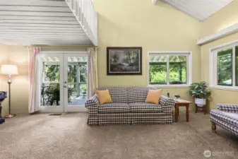 Living room with french doors leading to upper deck.