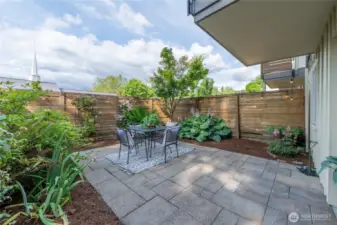 Fenced patio is the perfect spot for gardening and hanging out.