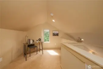 Loft space with a south-facing window. Could be an office, workout space, reading nook, or music space.