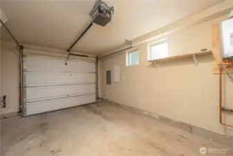 Attached garage for parking one car, or storage, or workout space. Tankless hot water heater is in the garage.