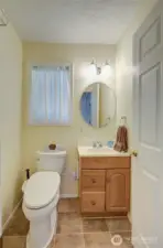 Exit the primary suite, and take a peek into the half bath.