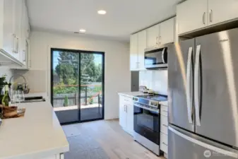 Gorgeous new kitchen features luxury stainless appliances, built-in microwave and beautiful countertops.