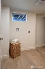 Laundry room with space for additional storage.