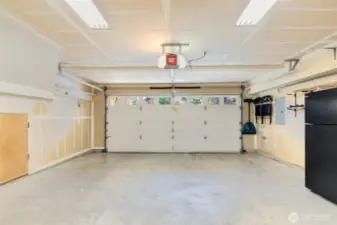 Spacious double garage with storage closet under stairs