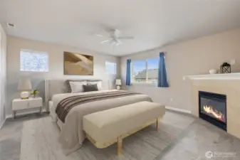 Primary bedroom with gas fireplace to keep you cozy. Virtually staged