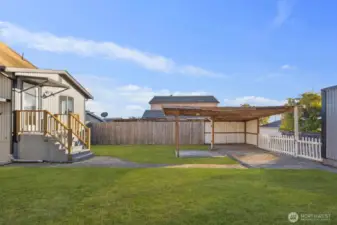 View of the detached garage and carport structure accessible from the alley, providing additional off-street parking.