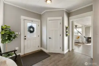 From the entry, the home opens naturally into the main living area, drawing you forward with natural light and an easy sense of flow. Wide openings and clear sightlines create a welcoming transition into the heart of the home. Large closet keeps eveything tidy.