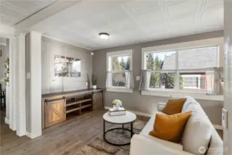 This living area feels comfortable and intentional, with a layout that supports everyday living without wasted space. Natural light from the windows keeps the room bright and inviting, while the neutral finishes make it easy to picture a variety of furniture styles and layouts. The cabinetry shown is not built in and can remain, offering flexible storage or media space without committing the next owner to a fixed design. Overall, it’s a relaxed, functional gathering space that works just as well for quiet evenings as it does for entertaining.