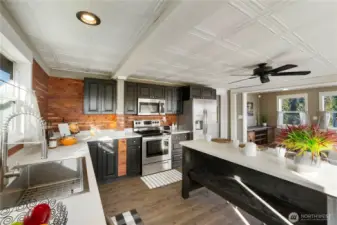This angle shows how thoughtfully the kitchen is laid out for real life, not just looks. The large island anchors the space and naturally becomes the gathering point for meals, conversations, and everyday routines. Dark cabinetry paired with warm wood accents gives the kitchen character without feeling heavy, while the clean countertops and stainless appliances keep it practical and easy to maintain. Large Handles Kitchen faucet makes cleaning a breeze.