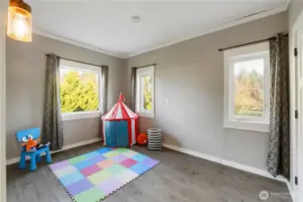 This bedroom is bright and flexible, with multiple windows bringing in natural light and soft outdoor views. The room layout works well for a guest bedroom, nursery, or home office, and the neutral finishes make it easy to adapt to different styles and uses. It’s a comfortable, versatile space that feels open without being oversized.