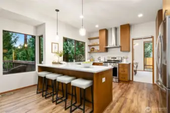 Completely reimagined kitchen featuring warm walnut cabinetry, brand-new appliances, and a raised ceiling that enhances the open, airy feel.