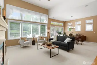 Surrounded by windows offering views of lush green landscaping, the main living areas feel light and airy.