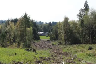Another view looking S. This shows the entry road off Cedar Creek Rd and the neighbor across the street.