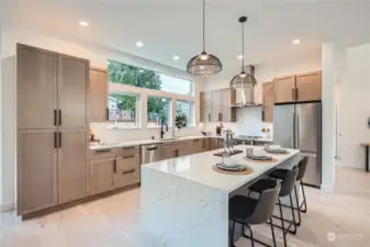 Timeless kitchen with custom cabinets and lovely lighting.