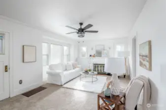 Enjoy this light-filled living room with wood fireplace