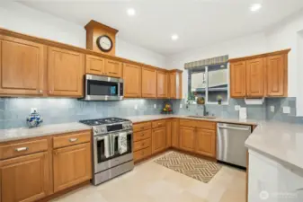 The remodeled kitchen features, new appliances, quartz countertops, tile backsplash, new sink and faucet