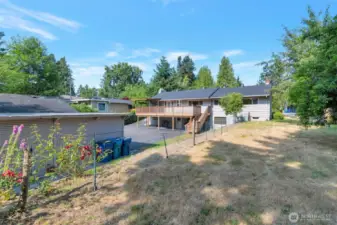 View from the rear of the property featuring the carport and fruit trees and garden space and the second tax lot