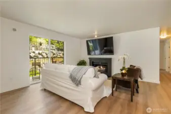 Cozy wood fireplace offers a great place to enjoy relaxation time. Step outside for fresh air and greenery on your own covered balcony