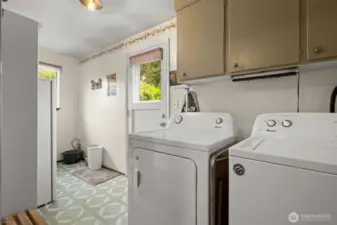 Large utility room leading to the back deck and yard.