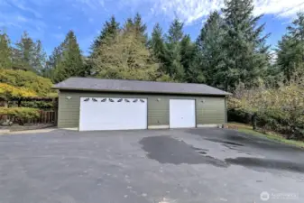 Large 3-bay garage. Inside there is a full wall that separates the 2-bay side from the 1-bay side. And the shared well is in its own room off of the back that has its own man door with a separate key so both well parties can access it if they need to.