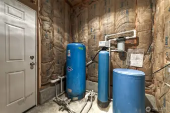 This is the shared well with the neighbor property. It has its own man door with a separate key that keeps it secure from the rest of the garage, yet accessible to both parties with interest in the well.