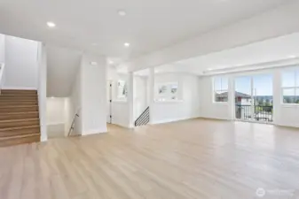 Expansive great room/dining room area with access to east facing deck.  Photo is of similar home-details & finishes will vary-ask site agent for details