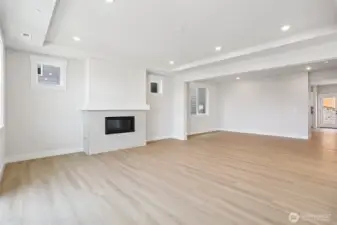 Great room/dining room warmed by a gas fireplace.  Photo is of similar home-details & finishes will vary-ask site agent for details
