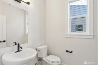 Powder room on main floor is conveniently located. Photo is of similar home-details & finishes will vary-ask site agent for details