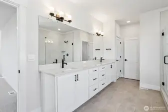 Dual vanity in primary bath showcases upgraded matte black fixtures/hardware. Photo is of similar home-details & finishes will vary-ask site agent for details