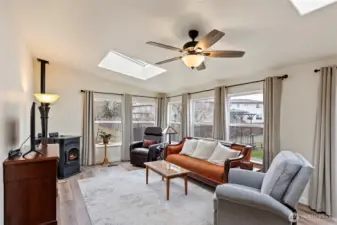 Awesome second living area! It's super bright and spacious, perfect for chilling or having guests over. And the pellet stove? It's the best - keeps things cozy and warm all winter long, making this house comfy all year!