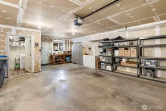 Two car garage plus, plus, plus!  Room for more storage, a work bench and a generous sized separate laundry room.