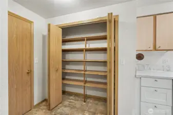 View of your pantry next to your kitchen - plenty of storage. Door to garage to your left.