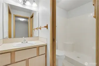 Primary ensuite bath, shower to your right with pocket door, walk-in closet to your left.