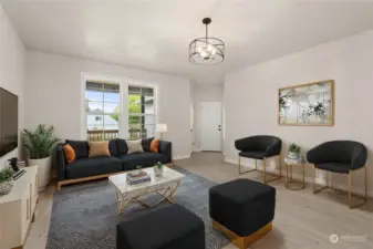 Front entry to a spacious living room.  Door in photo leads to the garage.