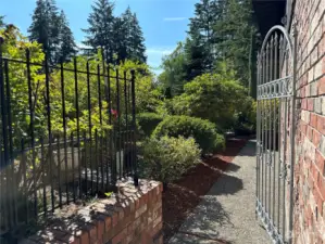 Sidewalk beside the garage coming to the back of the home.