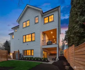 Back of the house that shows the 2 covered decks and the stately lines of the home