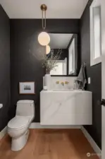 Elegant Powder room for your guests. Grasscloth wallpaper, custom sink and stunning light fixture