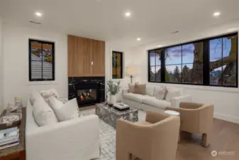 Cozy living room with marble and wood fireplace and views to the west for those evening sunsets.