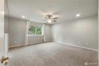 Primary bedroom faces green space.