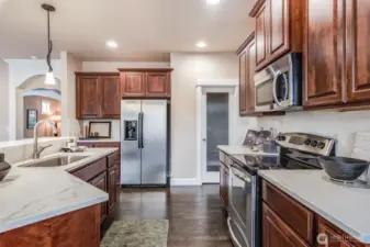 This chef’s kitchen blends form and function with quartz countertops, warm cabinetry, walk-in pantry and upscale stainless steel appliances. Whether you're hosting friends or savoring a quiet night in, it all begins here.