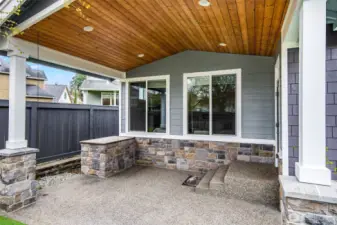Enjoy a seamless indoor-outdoor lifestyle all year round, with this inviting patio space w/granite BBQ prep area, tucked beneath a wood-paneled ceiling w/recessed lighting.