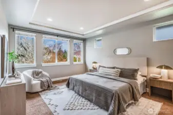Bathed in natural light, this elegant Primary Suite offers a peaceful retreat with coffered ceilings, serene views, and a layout designed for ultimate comfort.