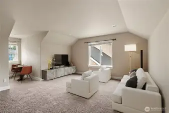 Expansive bonus room ideal for movie nights, a gym, gaming or playroom.   Photo virtually staged.