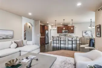 Light-filled living area with large windows and neutral tones creates a warm, inviting space.