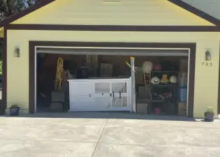 Garage Conversion has a false wall in back, accessed from inside the home as a separate Multi-USE Space.  The remaining garage area you see here is currently used for storage only. (No room for parking a vehicle however if the future buyer prefers a garage over extra interior square footage then the dividing wall can be removed and the garage be in full use again at buyers discretion.  Off street parking available in this private and dedicated driveway which is only used for this house.