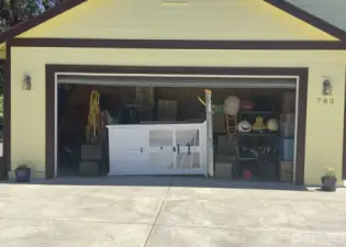 Garage Conversion has a false wall in back, accessed from inside the home as a separate Multi-USE Space.  The remaining garage area you see here is currently used for storage only. (No room for parking a vehicle however if the future buyer perfers a garage over extra interior square footage then the dividing wall can be removed and the garage be in full use again at buyers discretion.  Off street parking available in this private and dedicated driveway which is only used for this house.    be coverted back to garage by buyer if they so wish.