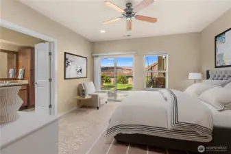 Tranquil primary bedroom with generous layout and large windows for natural light
