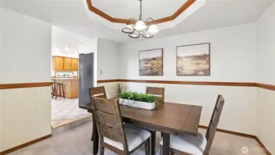 This formal dining space featuring beautiful tray ceiling offers the perfect space for intimate dinners or large gatherings!