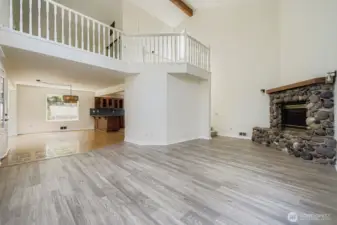 Large family/living room with striking river rock fireplace